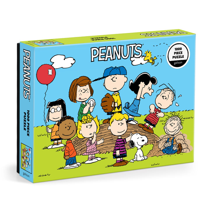 The Peanuts Baseball 1000 Piece Puzzle by Peanuts Worldwide LLC. features Charlie Brown, Snoopy, and friends outdoors with a blue sky and red balloon—ideal for puzzle enthusiasts and Peanuts fans.