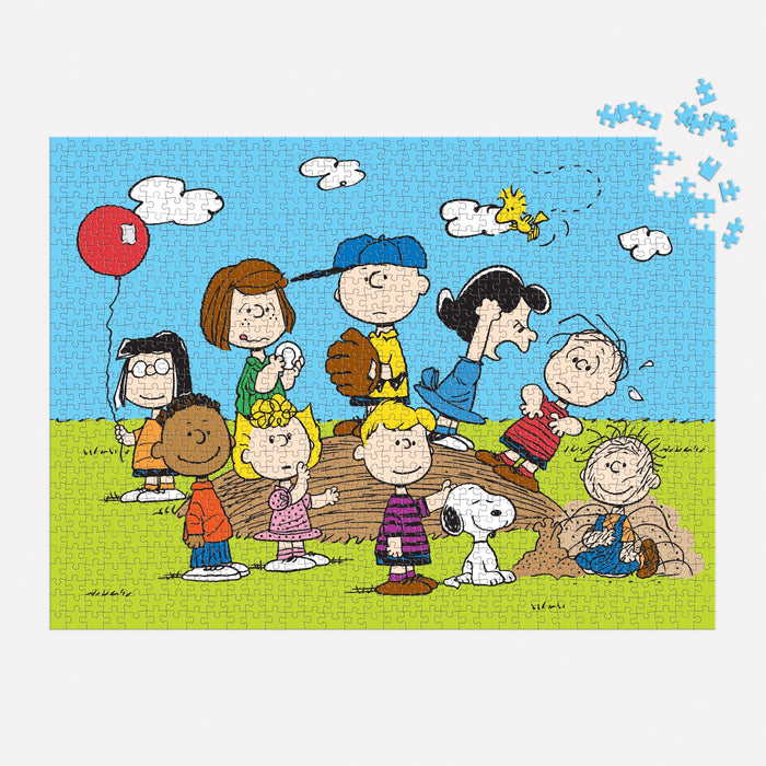 The Peanuts Baseball 1000 Piece Puzzle by Peanuts Worldwide LLC. features Charlie Brown, Snoopy, Woodstock, and friends on a grassy field under a blue sky—perfect for Peanuts fans and puzzle lovers to enjoy completing together.