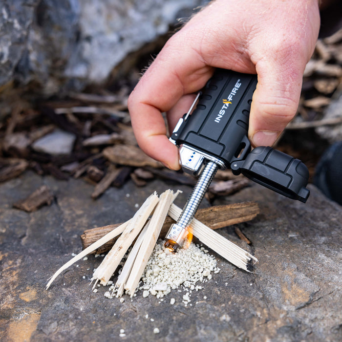 Pocket Plasma Lighter by InstaFire in use lighting a campfire.