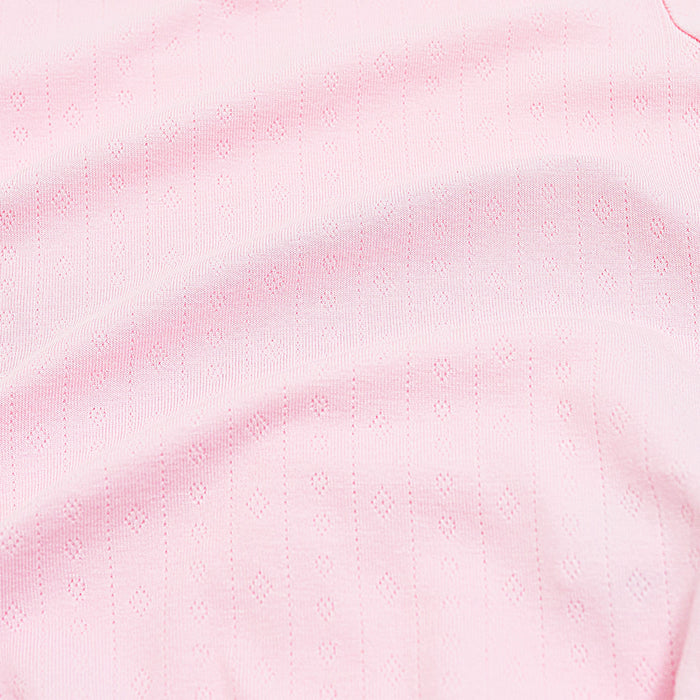 Close up of the pointelle fabric showing the light pink color