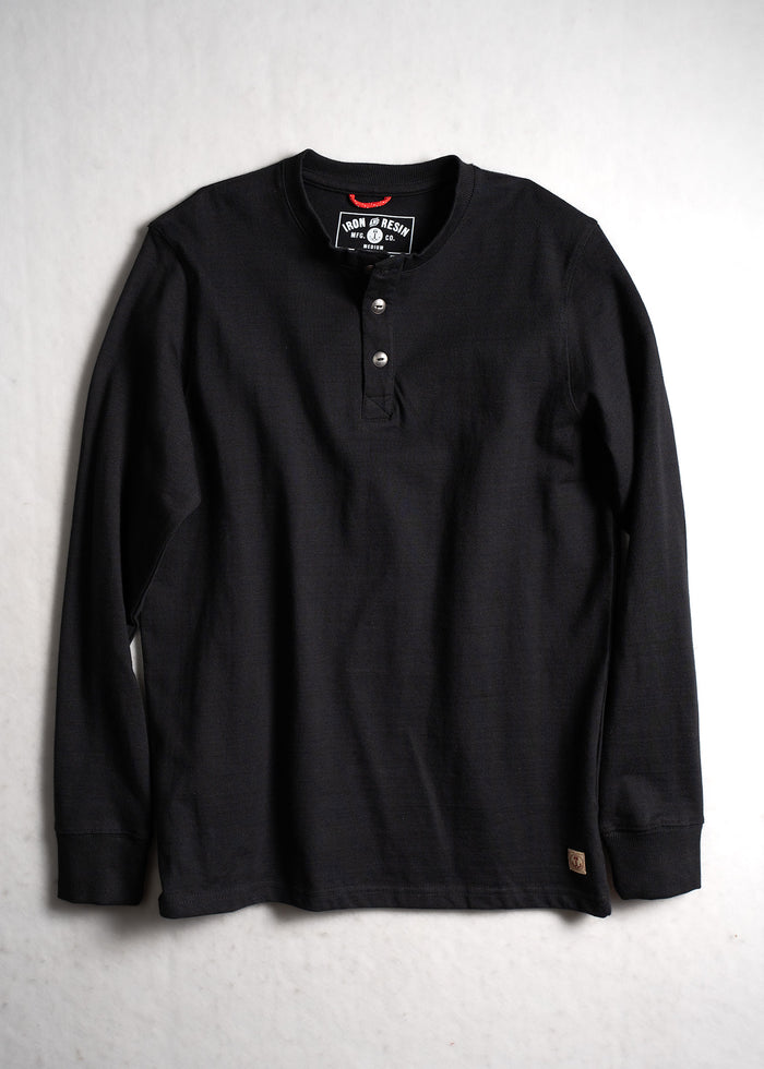 Black long-sleeve henley shirt with three buttons, laid flat on a light surface. Iron & Resin label visible inside the collar.