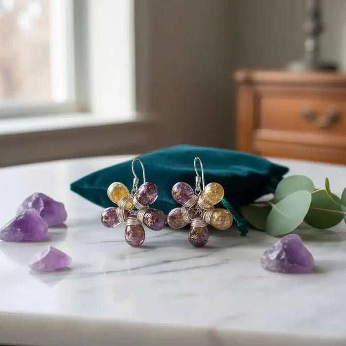 Purple and Yellow Flower Sterling Silver Earrings displayed on a marble surface with amethyst crystals.
