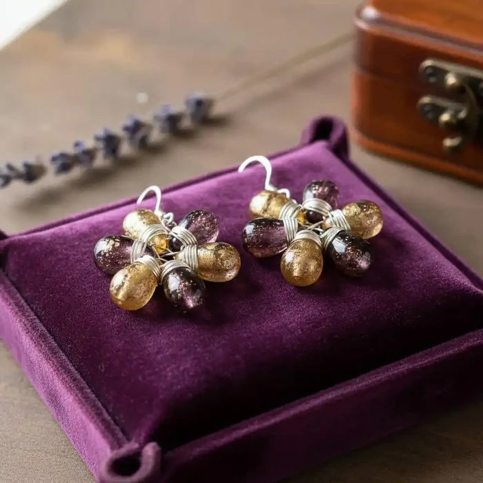 Purple and Yellow Flower Sterling Silver Earrings displayed on a purple velvet box.