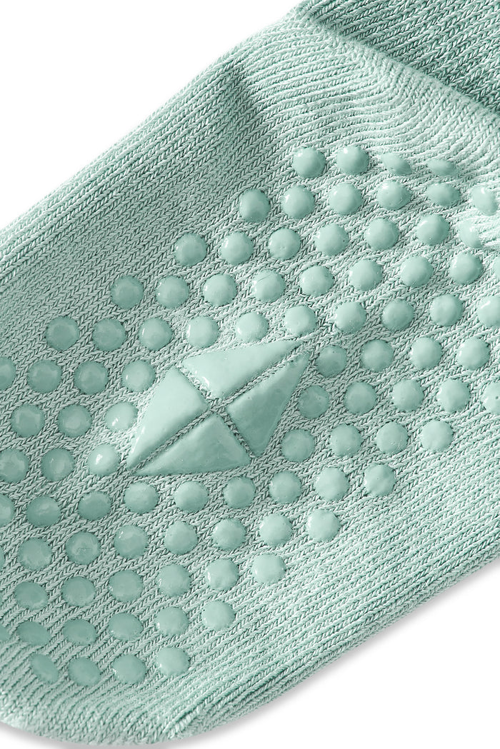 Angled bottom of a Kyte sock with grips.