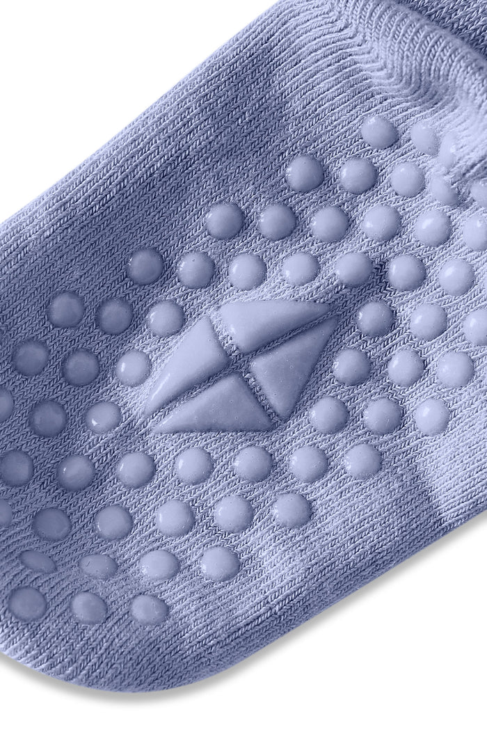 Angled bottom of sock with grips.