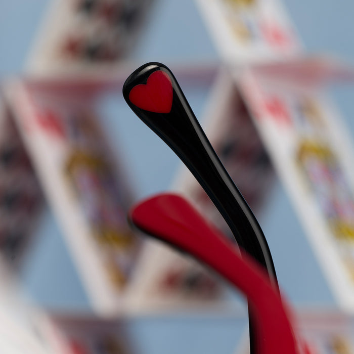 still life - diff eyewear x disney alice in wonderland queen of hearts square oversized sunglasses detailed view of temple tip with queen of heart