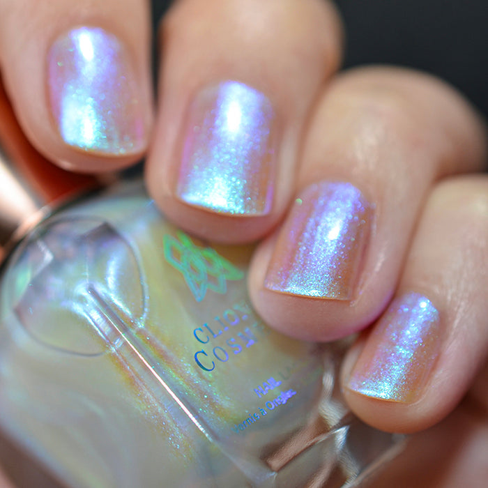 Close up shot of nails done with Radiance nail lacquer on fair skin tone holding the nail lacquer bottle