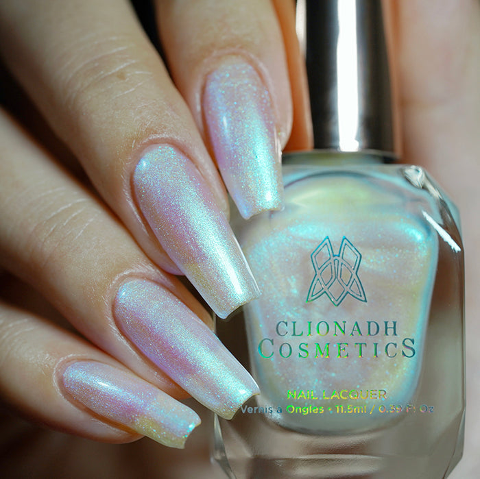 Close up shot of nails done with Radiance nail lacquer on fair skin tone holding the nail lacquer bottle