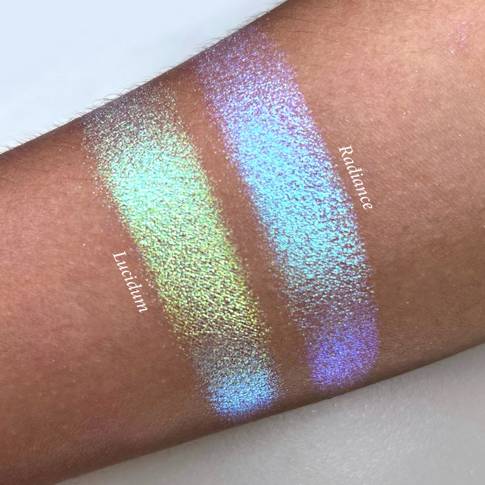 Top angled arm swatches on medium skin tone of Radiance Series 2 Iridescent Multichrome Eyeshadow shifts compared to Lucidum
