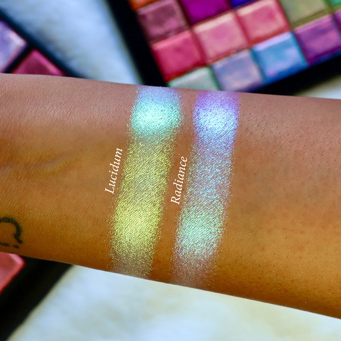 Straight angled arm swatches on medium skin tone of Radiance Series 2 Iridescent Multichrome Eyeshadow shifts compared to Lucidum