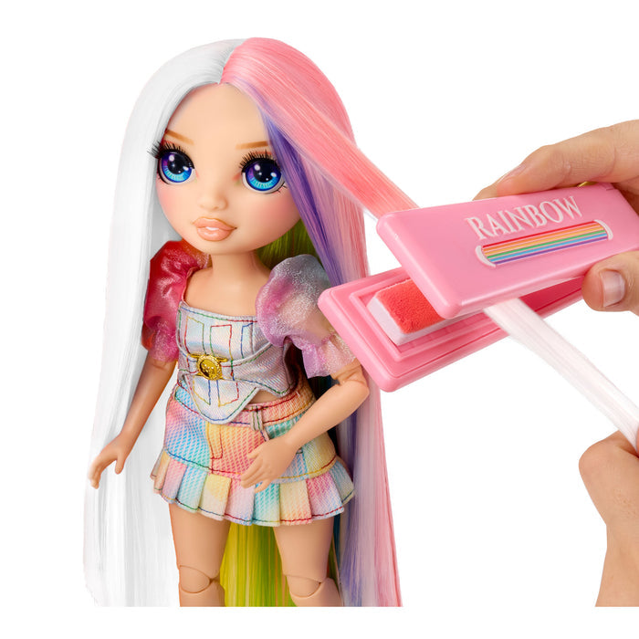 Colorful doll with a hair coloring tool labeled 'Rainbow' on a white background