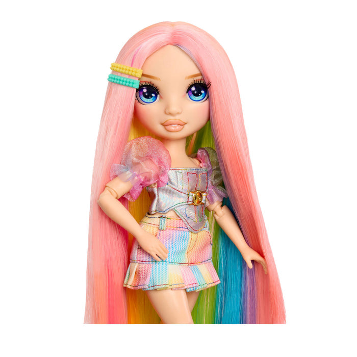 Doll with pink hair and colorful outfit on a white background