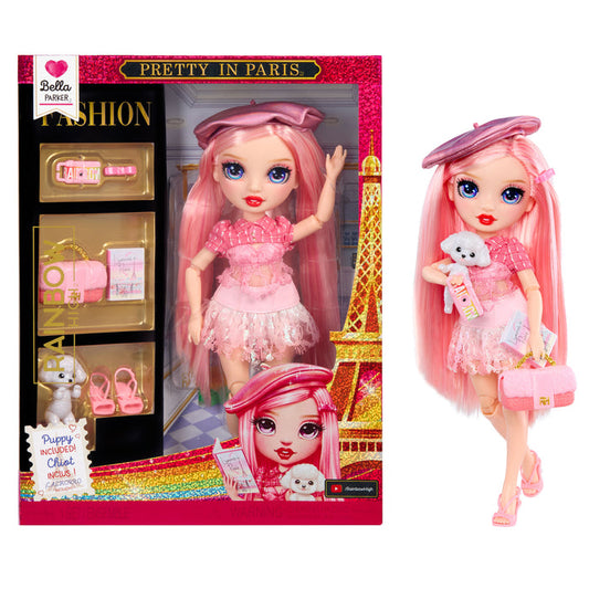 Toy doll with pink hair and outfit, standing next to its packaging featuring the Eiffel Tower.