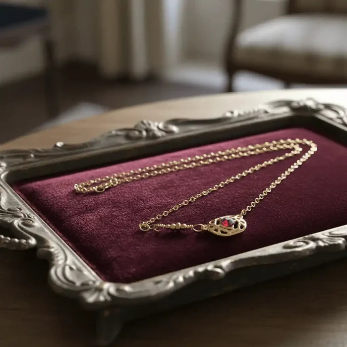 Red Crystal 14 K Gold Filled Adjustable Filigree Choker displayed on a velvet background in an ornate frame.