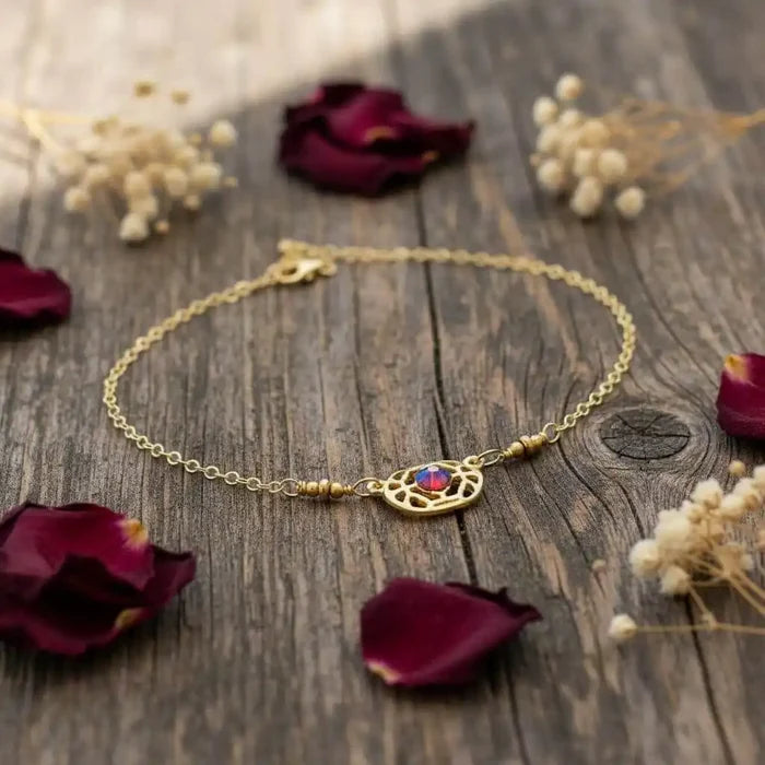 Red Crystal 14 K Gold Filled Adjustable Filigree Choker displayed on rustic wood with rose petals.
