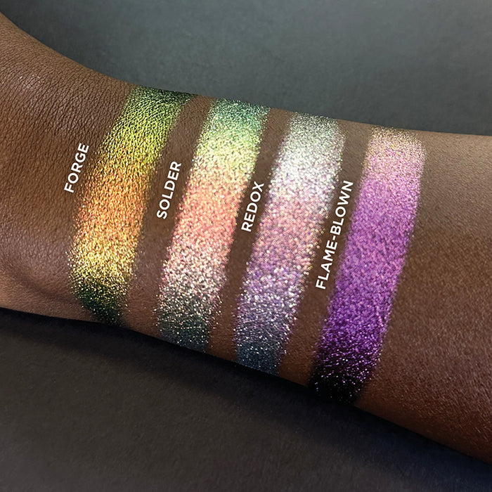 Arm swatches on deep skin tone of Redox Dimensional Multichrome Eyeshadow shifts compared to Forge, Solder and Flame-Blown