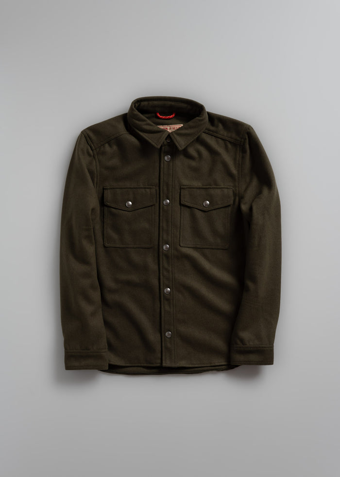 Olive green button-up shirt with two chest pockets and a collar, displayed on a plain gray background.
