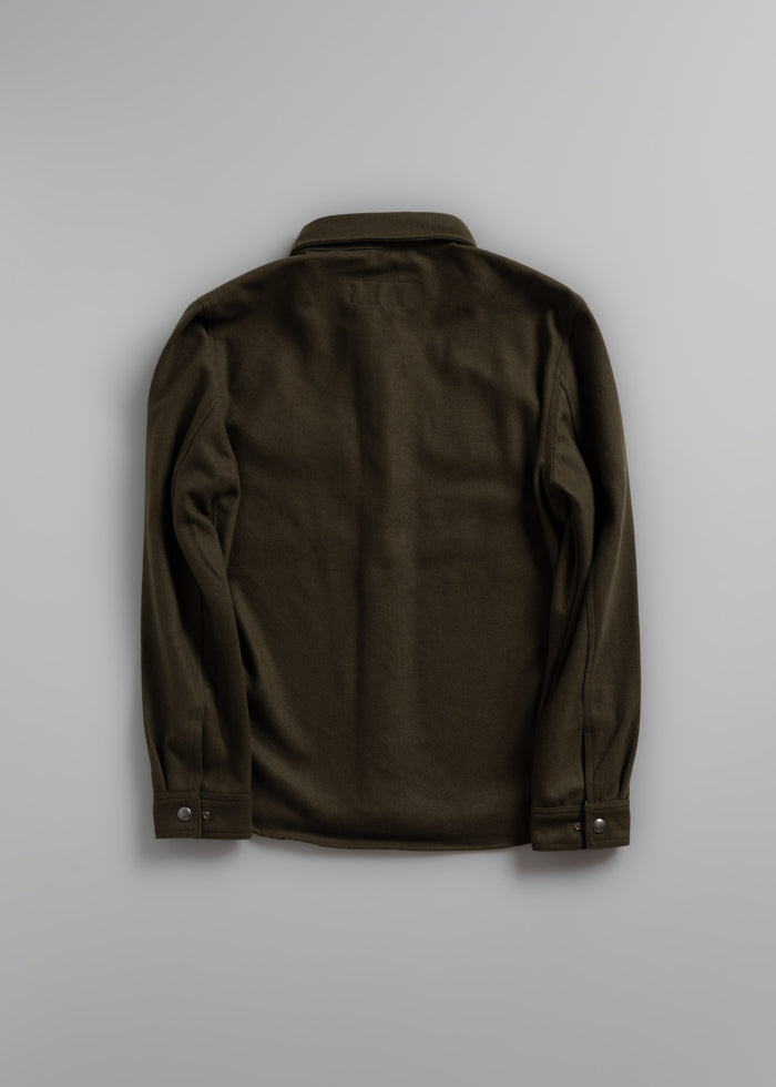 Dark green jacket displayed from the back on a plain gray background, highlighting its simple design and buttoned cuffs.