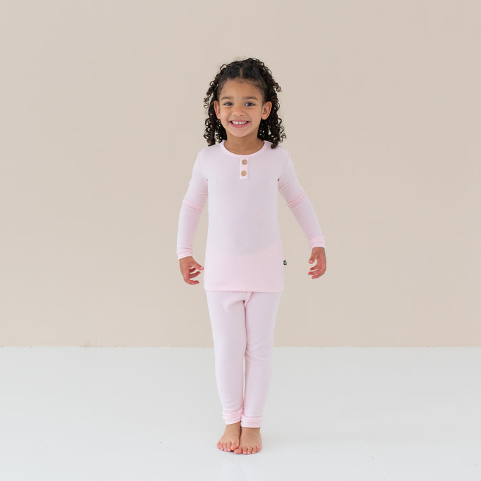 Toddler smiling modeling Ribbed Henley Set in Sakura