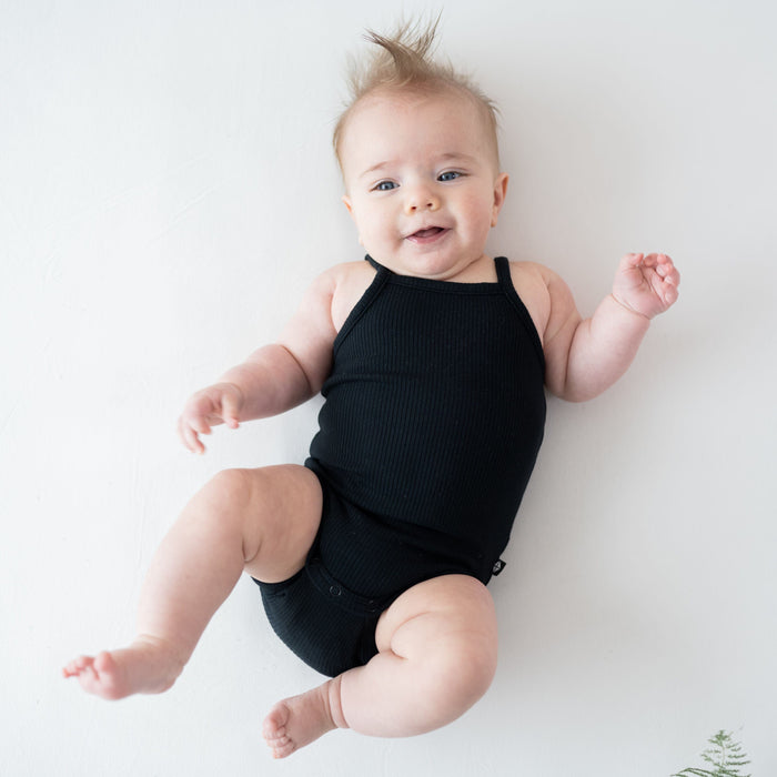 Infant wearing Kyte Baby Ribbed Spaghetti Strap Bodysuit in Midnight