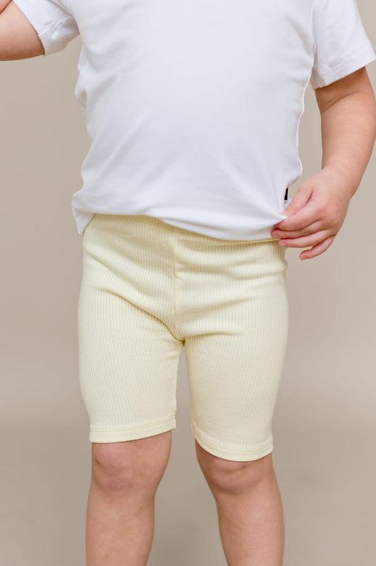 Close up of the Ribbed Toddler Biker Shorts in Chamomile shown on a toddler