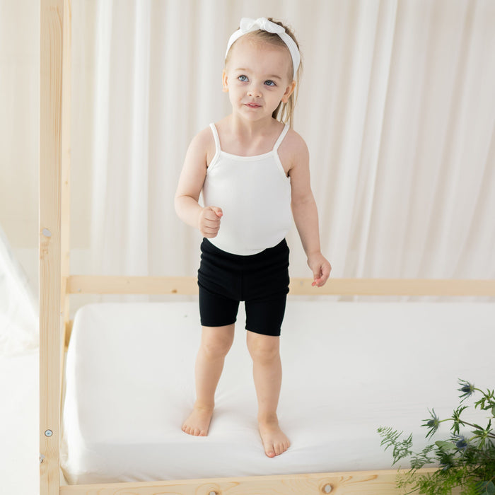 Toddler wearing Kyte Baby Ribbed Biker Shorts in Midnight