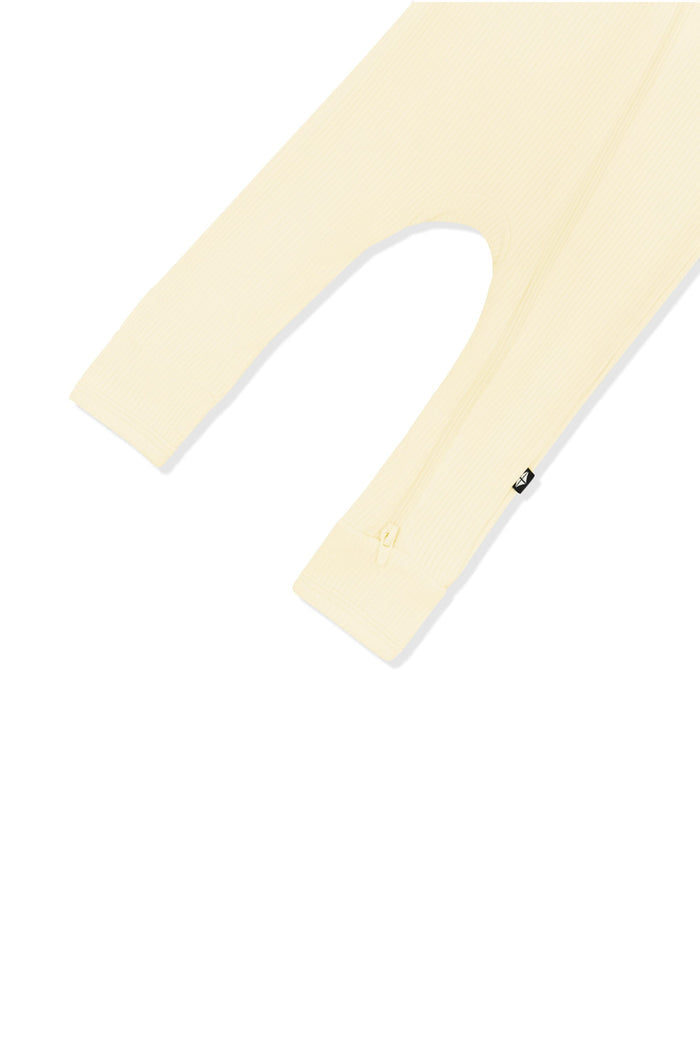 Close up of the zipper closure on the leg of the Ribbed Zipper Romper in Chamomile