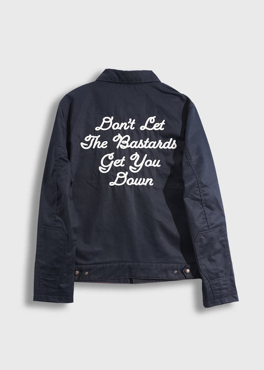 Navy jacket with bold white text: "Don't Let The Bastards Get You Down" on the back, conveying a strong motivational message.