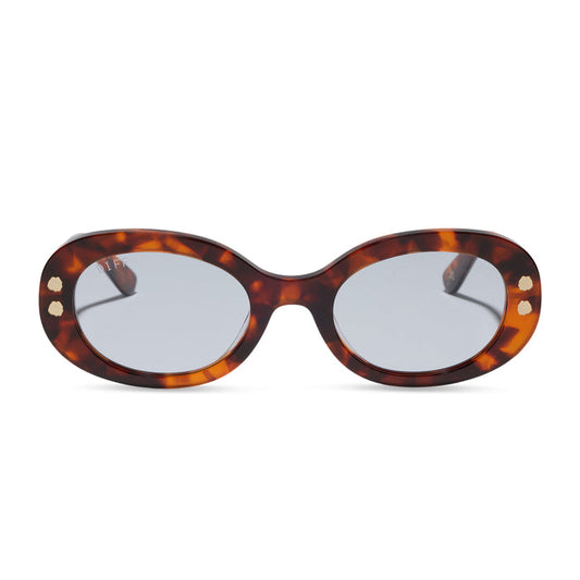diff eyewear x practical magic 2 featuring the sally oval sunglasses with a tortoise frame and light blue lenses front view