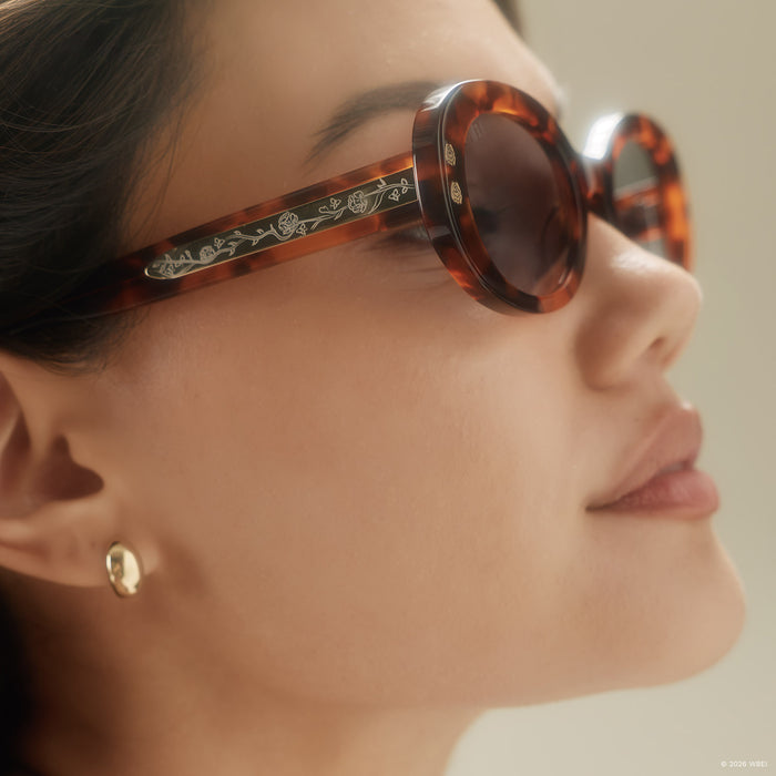 on model - female wearing diff eyewear x practical magic 2 sally oval sunglasses with a tortoise frame and light blue lenses detailed temple view