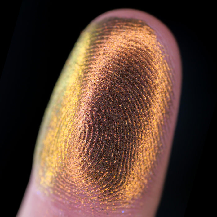 Macro finger swatch of Sand Blast Lite on fair skin tone.