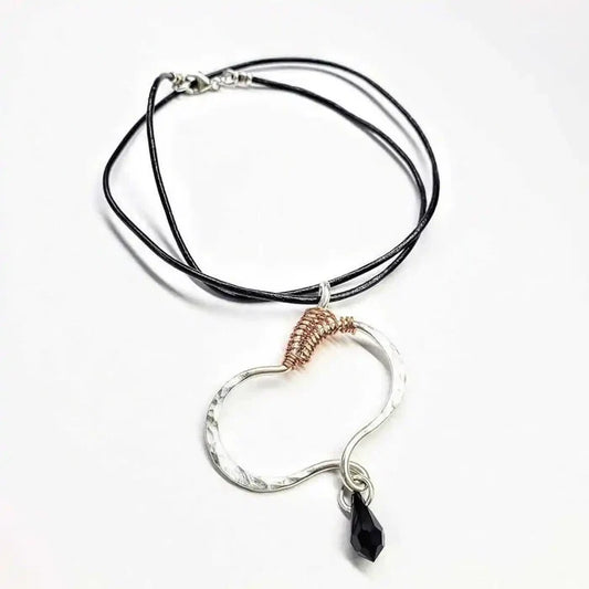Sculpted Silver Butterfly Wing Child Abuse Survivor Necklace on braided leather cord with unique pendant design.