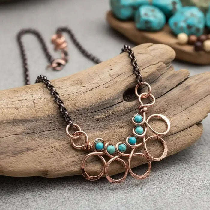 Seen on Ashley Liao Copper Turquoise Wire Wrapped Necklace on a wooden display.