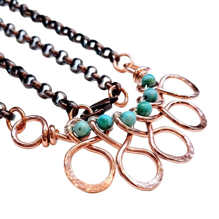 Seen on Ashley Liao Copper Turquoise Wire Wrapped Necklace on a black chain with looped pendants.