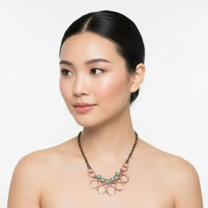 Seen on Ashley Liao Copper Turquoise Wire Wrapped Necklace worn by a model with a neutral background.
