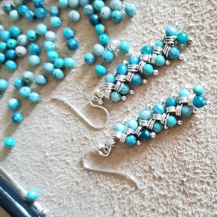 Seen On Jane The Virgin Silver Turquoise Wire Coil Earrings with turquoise beads and silver wire.