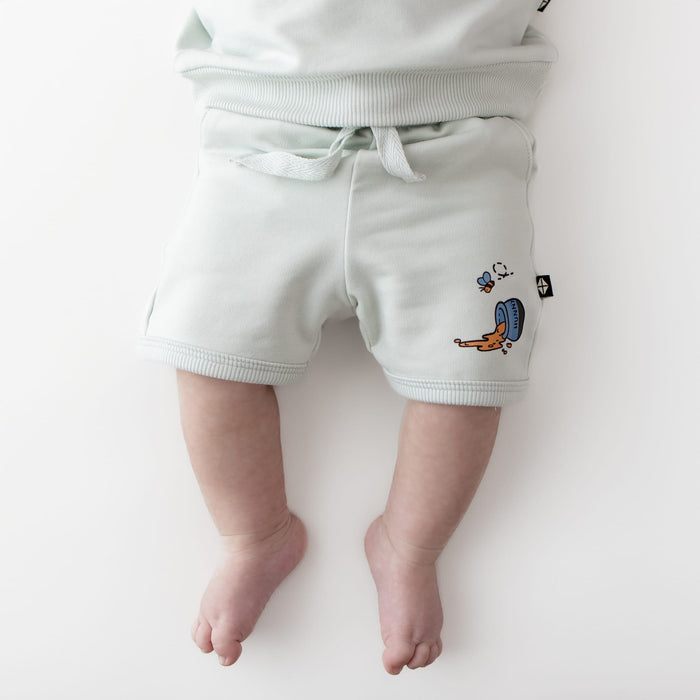 Close up of the shorts on the Short Sleeve Jogger Set in Winnie the Pooh on Dew shown on an infant model