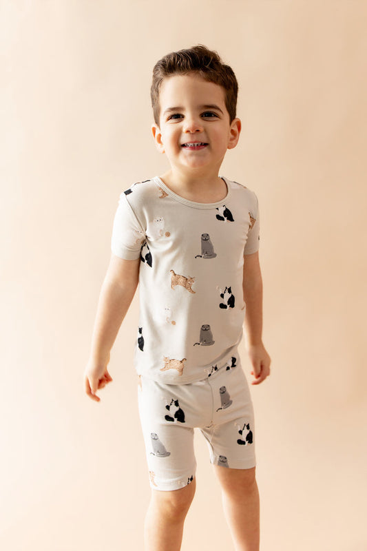 Young boy wearing the Short Sleeve Pajamas in Fluffy Cat