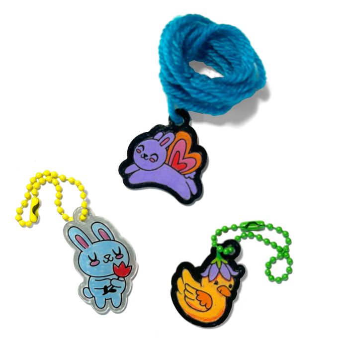 Three completed charms of rabbits and a duck from OOLY Shrink-its! DIY Shrink Art Kit - Garden Pals