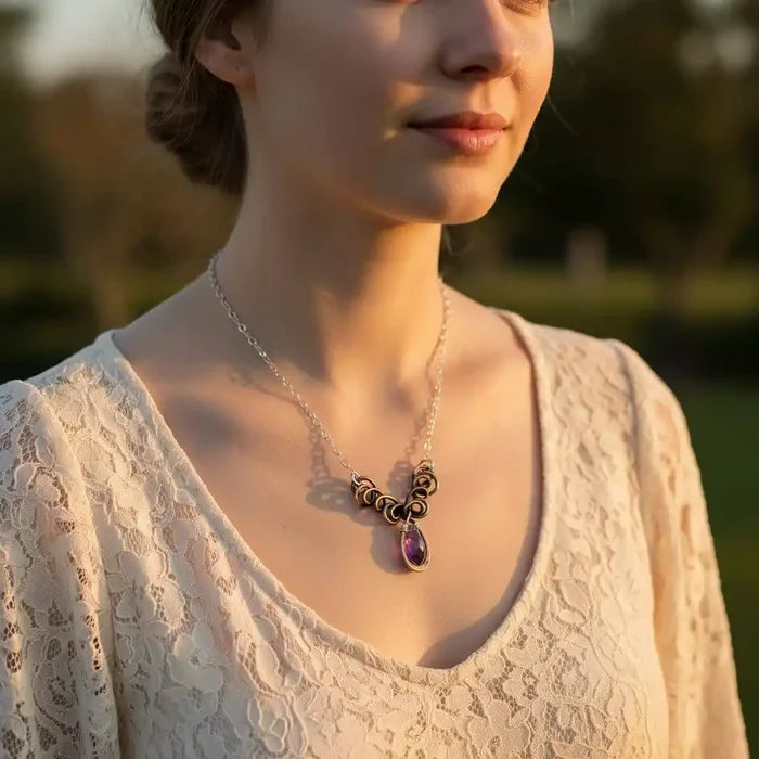 Silver and Copper Wire Sculpted Purple Crystal Drop Necklace worn by a woman, showcasing its unique design and sparkling crystal.