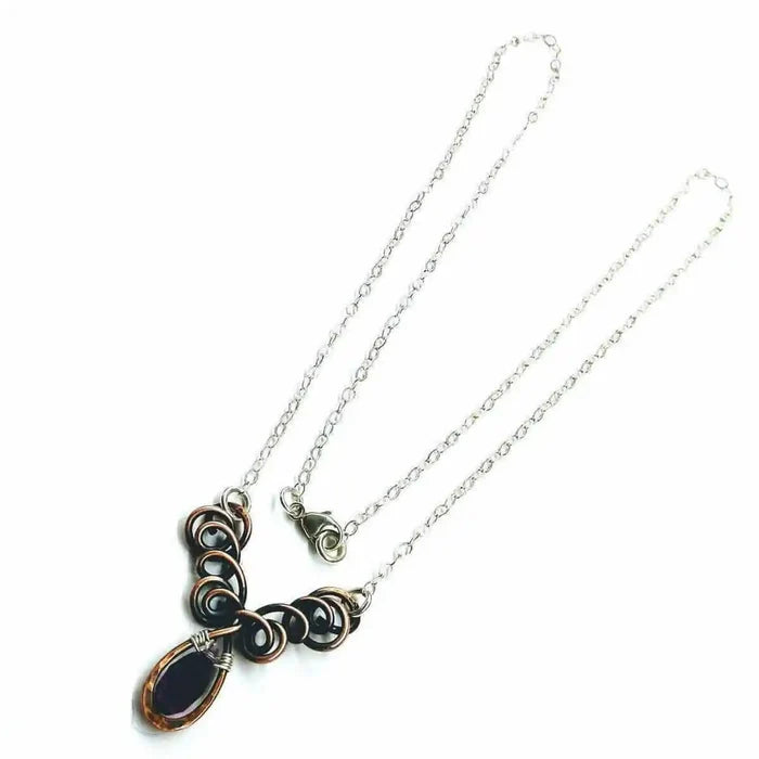 Silver and Copper Wire Sculpted Purple Crystal Drop Necklace featuring unique wire sculpture and an amethyst Swarovski drop.