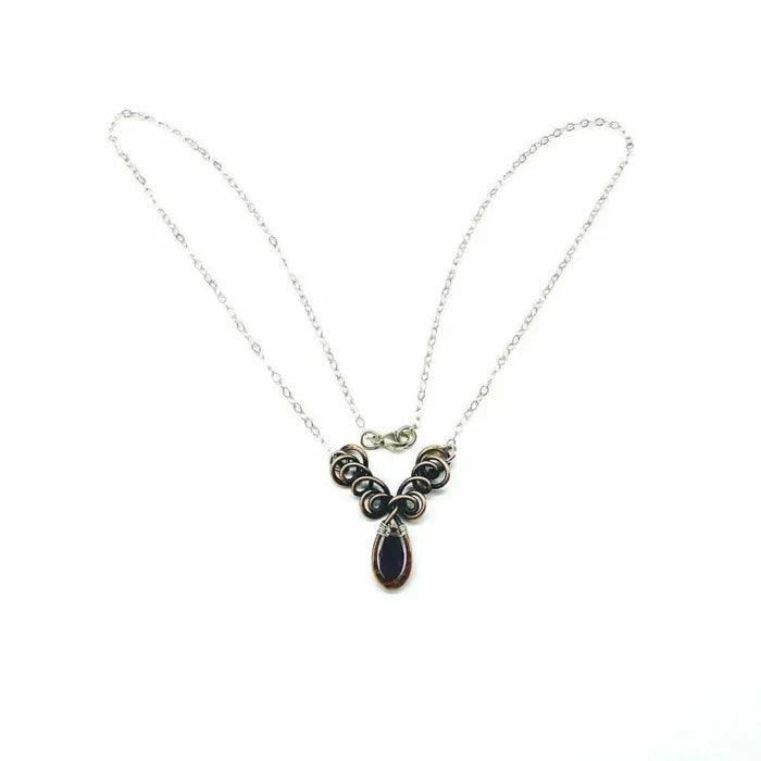 Silver and Copper Wire Sculpted Purple Crystal Drop Necklace showcasing a beautiful purple crystal drop with unique wire design.