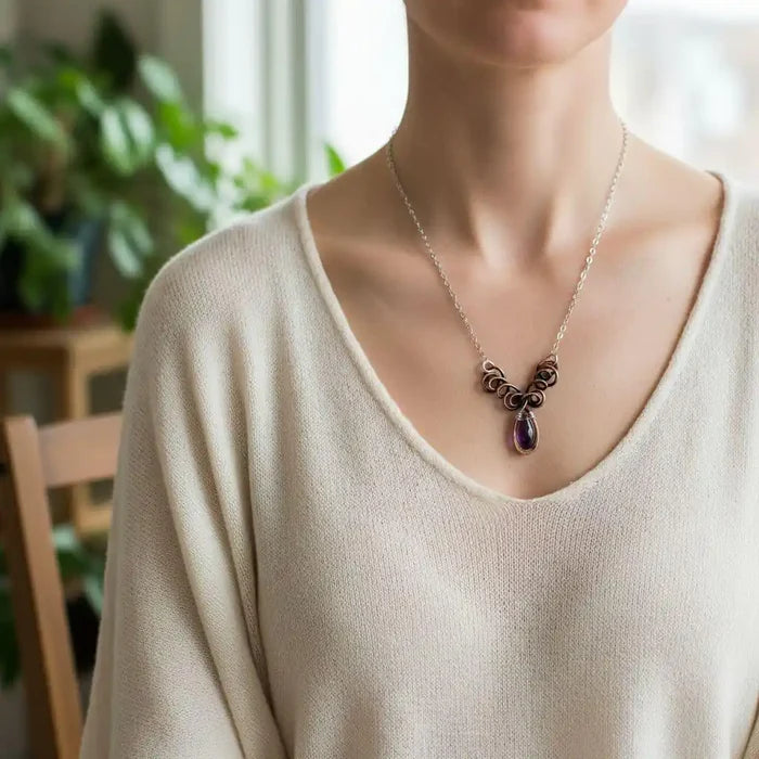 Silver and Copper Wire Sculpted Purple Crystal Drop Necklace worn by a model showcasing its artisan elegance.
