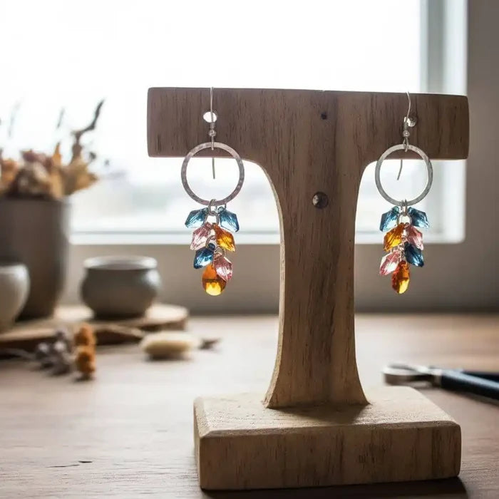 Silver Circle Multi Color Crystal Drop Dangle Earrings displayed on wooden stand with vibrant crystals shimmering.