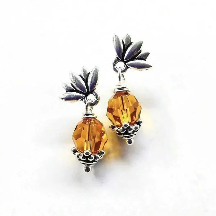 Silver Crystal Pineapple Steel Studded Earrings with round topaz and leaf design, offering tropical charm.