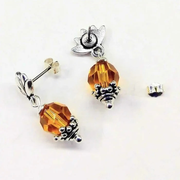 Silver Crystal Pineapple Steel Studded Earrings featuring an 8mm round topaz and unique pineapple design.