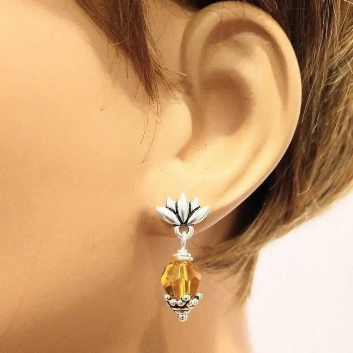Silver Crystal Pineapple Steel Studded Earrings showcased on a mannequin ear with yellow crystal detail.