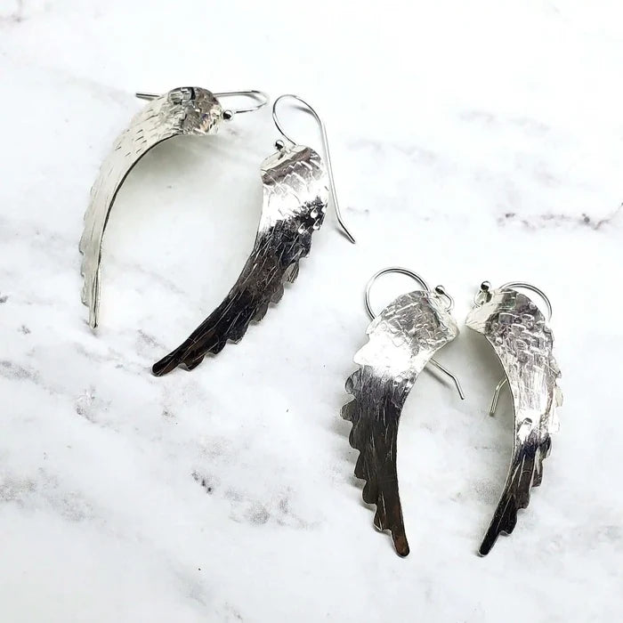 Silver Hammered Sculpted Angel Wing Earrings showcasing handcrafted design and intricate hammer-pattern texture.