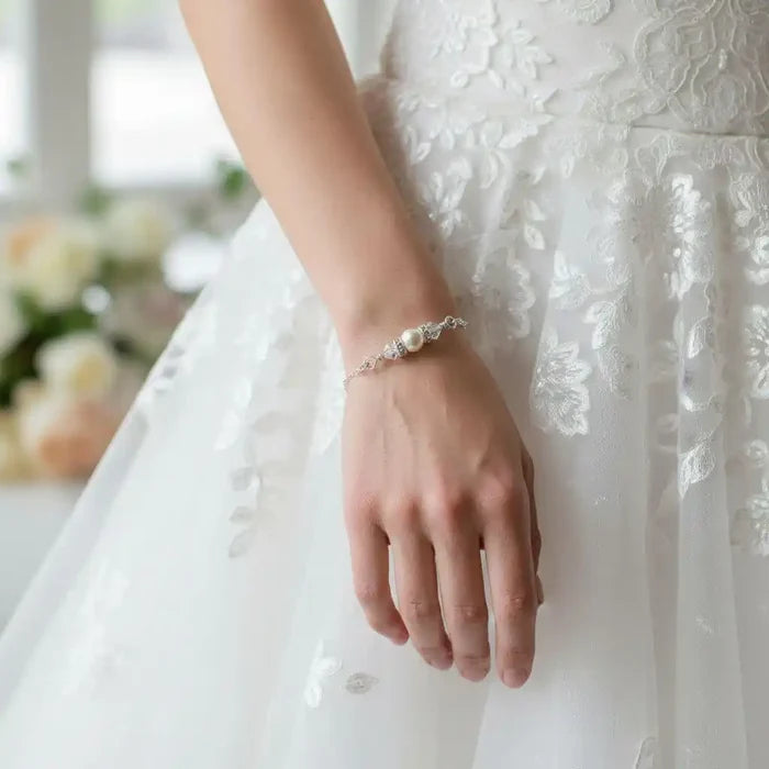 Silver Swarovski Crystal Pearl Bar Bridal Bracelet worn by a bride with intricate lace wedding dress.