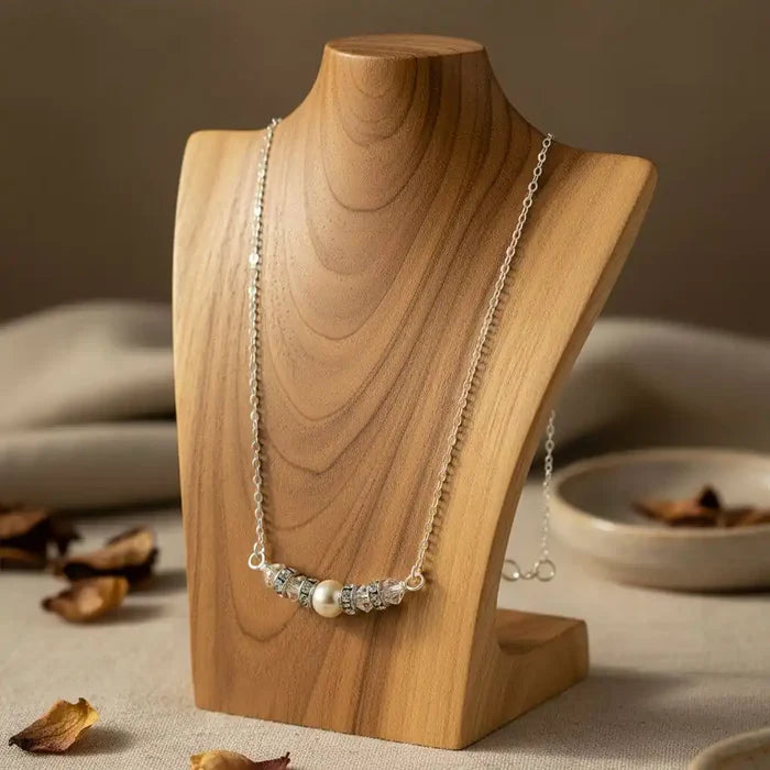 Silver Swarovski Crystal Pearl Bar Bridal Necklace displayed on a wooden bust with a soft background.